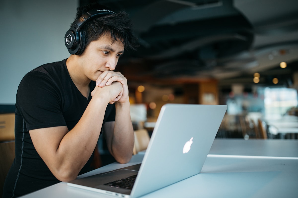 Student learning online with laptop and headphones